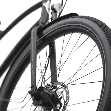 Close-up of a bicycle wheel with disc brake system on a white background