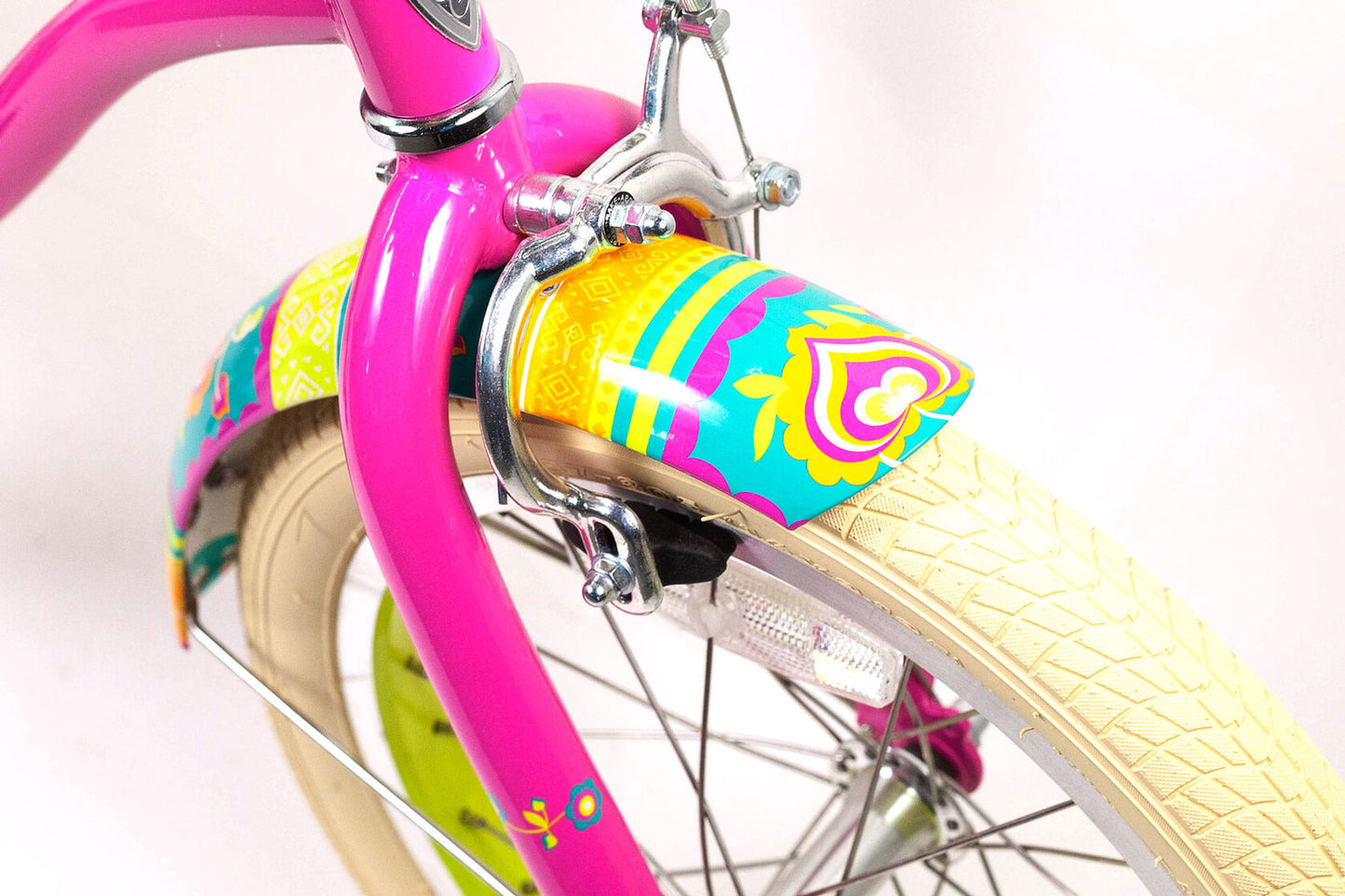 Close-up of a colorful bicycle handlebar with pink frame and yellow rim.