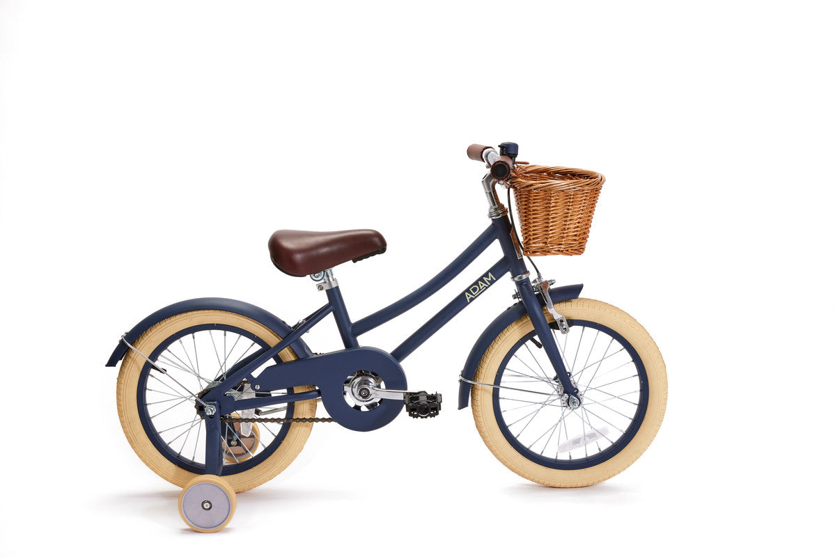 Dark blue children's bicycle with a brown basket on a white background