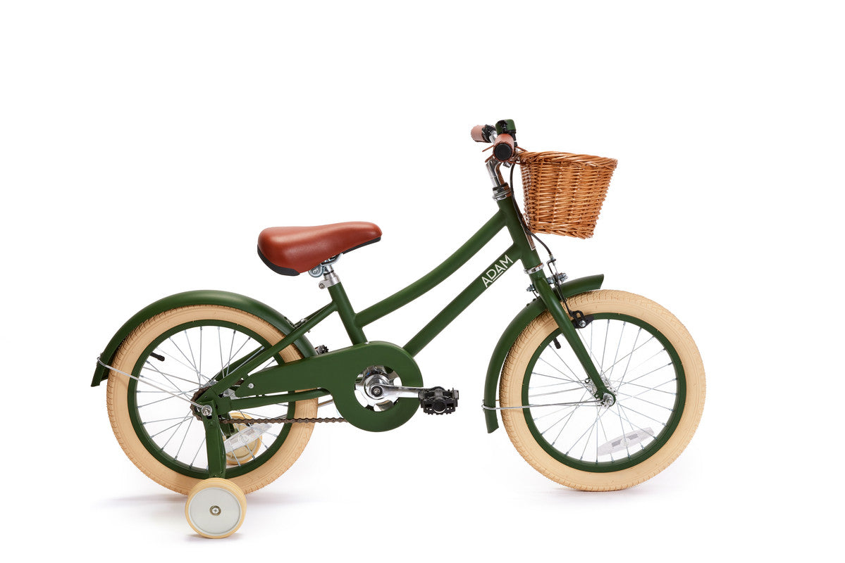 Green children's bicycle with a basket on a white background