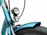 Close-up of a blue bike with headlight and handlebar controls on a white background