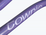 Close-up of a purple handlebar with 'townie' branding on a white background