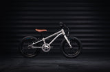 Children's bicycle with a brown seat on a dark background