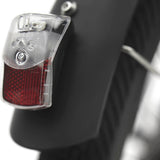 Close-up of a bicycle tail light attached to a bike frame.