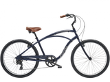 Navy blue bicycle with brown seat on a white background