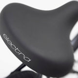 Close-up of a black bicycle seat with 'electra' branding on a white background