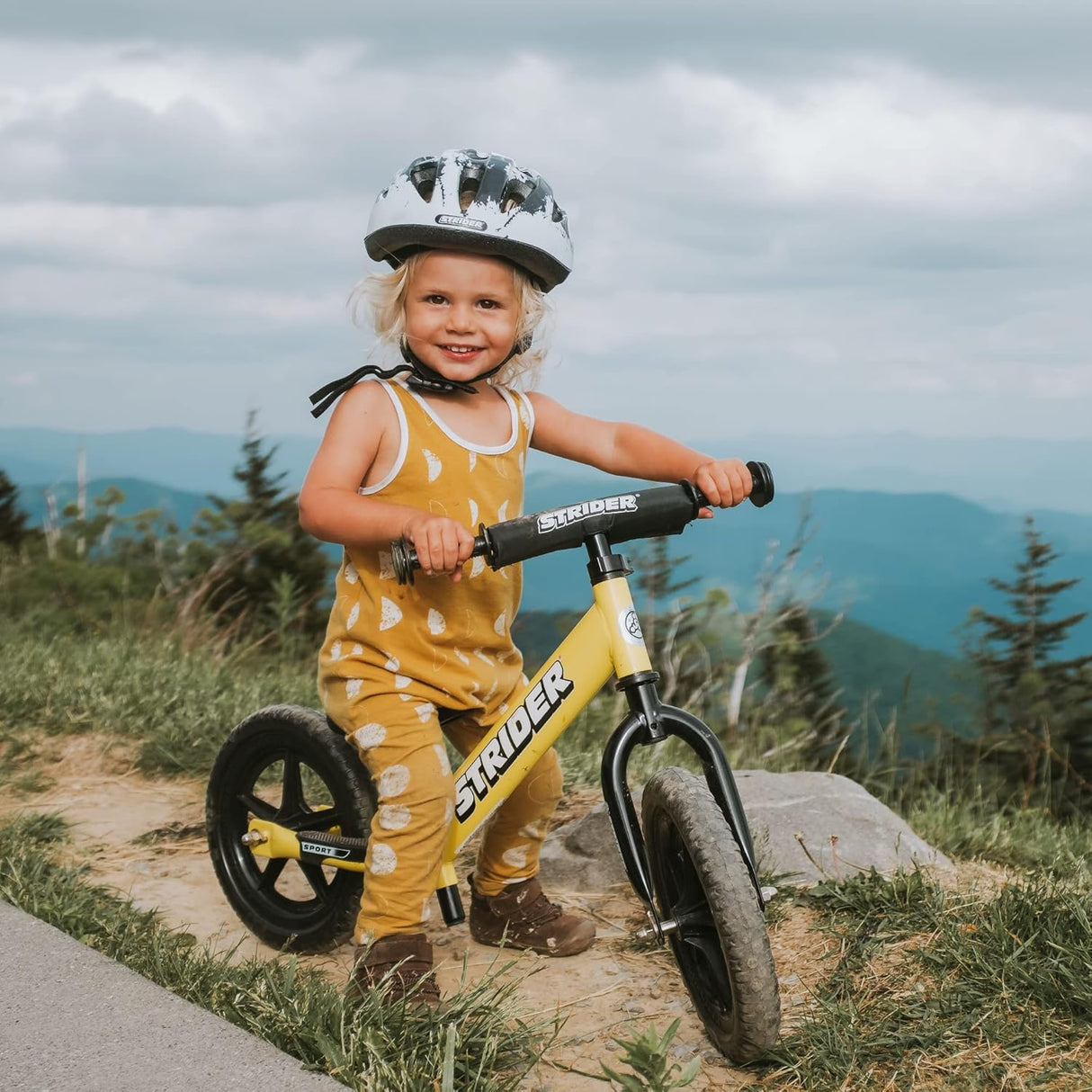 Child with a balance bike in a natural setting
