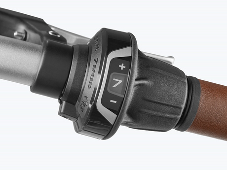 Close-up of bicycle gears with control buttons on a white background