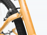 Close-up of a bicycle frame with 'Flat Foot Technology' branding on a white background