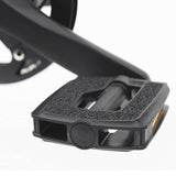 Close-up of a black bicycle pedal on a white background