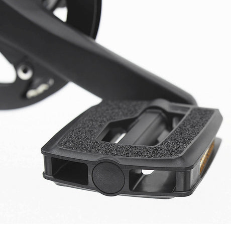 Close-up of a black bicycle pedal on a white background